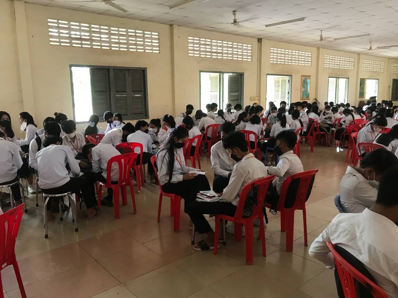 A large group of young participants working through an ABL session in small circles of chairs