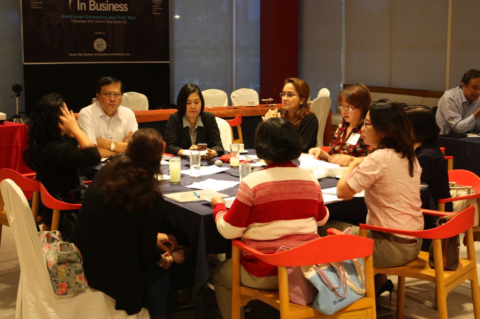 Participants around a table at an ILO Ready for Business hand-over ceremony