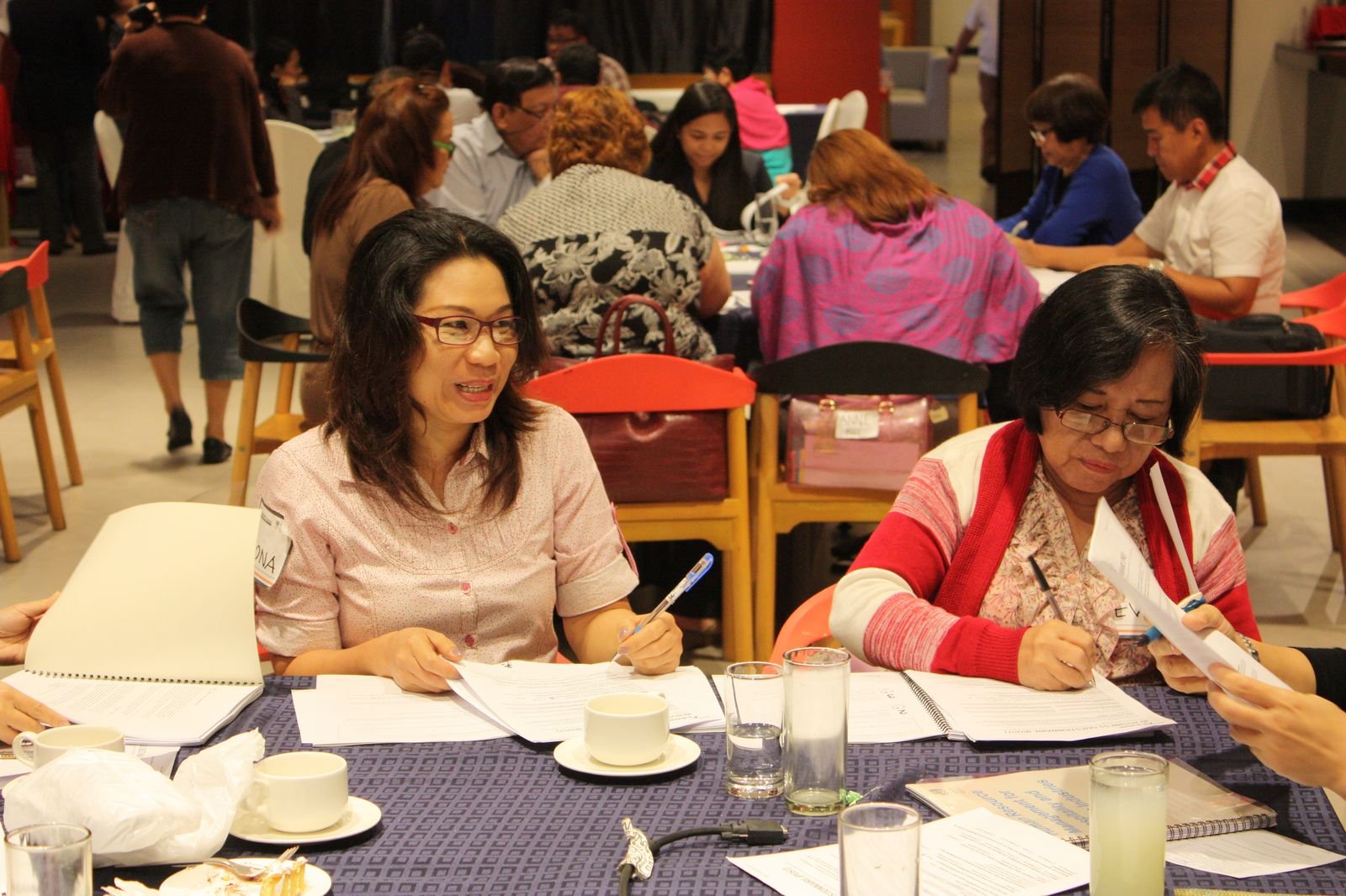 A group of participants seated around a table discussing training materials